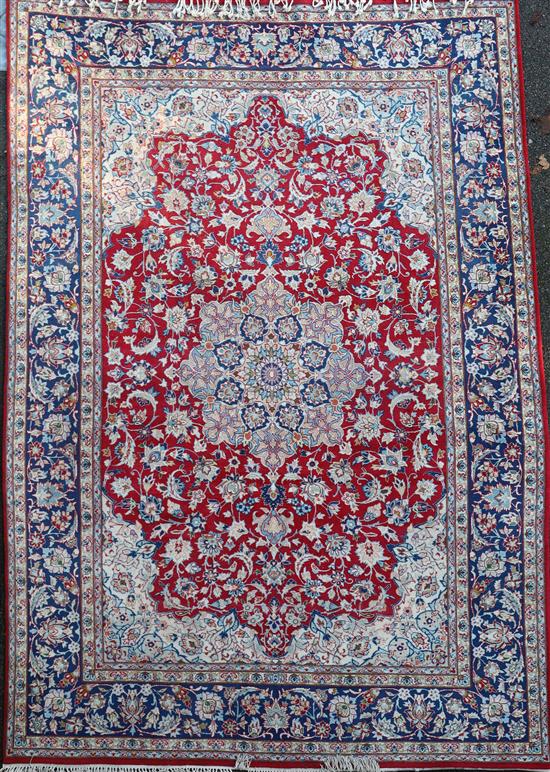 A Kirman red ground carpet, 12ft 1in by 8ft 10in.